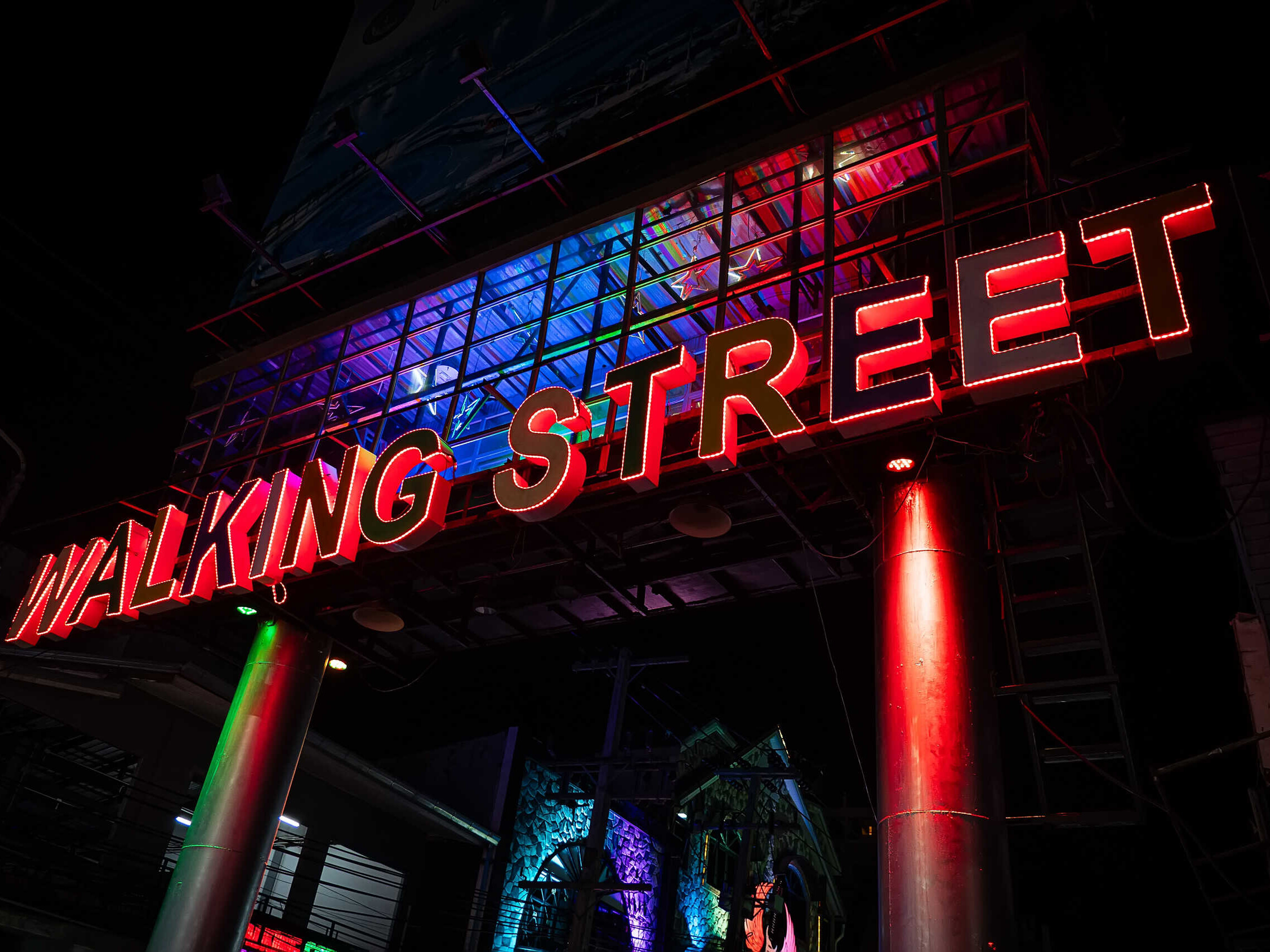 View of Pattaya walking street with various neon sign boards. Sign on Walking Street